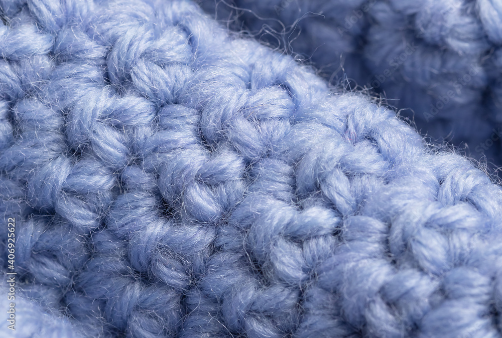 close-up of knitting of front and back loops on a lilac textured woolen background. Handicraft concept. close-up of knitting of front and back loops on a lilac textured woolen background. Handicraft concept.