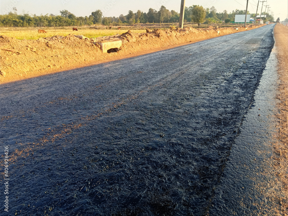 Naklejka premium Rubber spraying for preparation of pavement In road construction