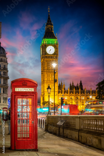 Photography Red telephone booth in front of the illuminated Big Ben clocktower in London, Un