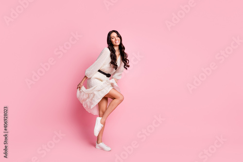 Full length body size photo of female student wearing fashion dress wavy hairstyle smiling isolated on pastel pink color background