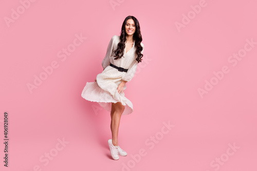 Full length body size photo of female student wearing white stylish dress dancing at party isolated on pastel pink color background