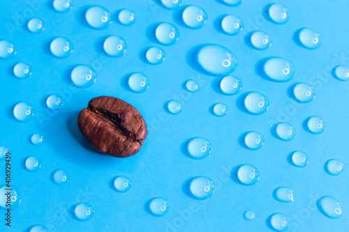 Coffee bean closeup whit water drops on a blue background 