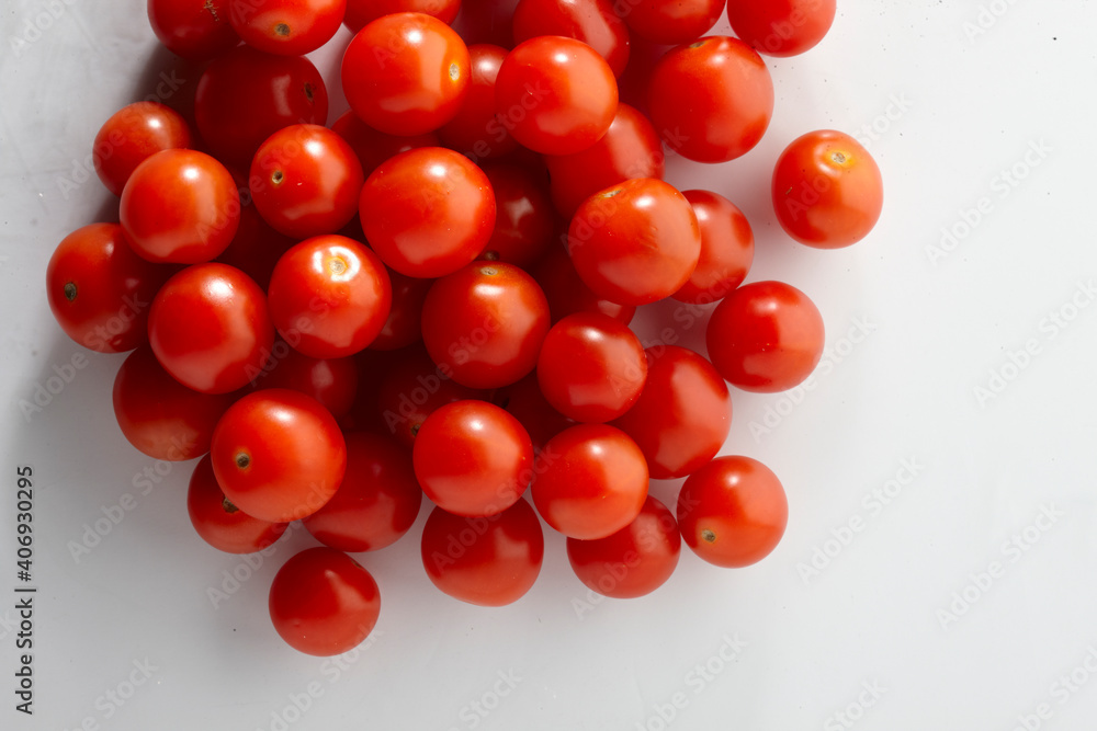 Pile of fresh tomatos on a white background Pile of fresh tomatos on a white background