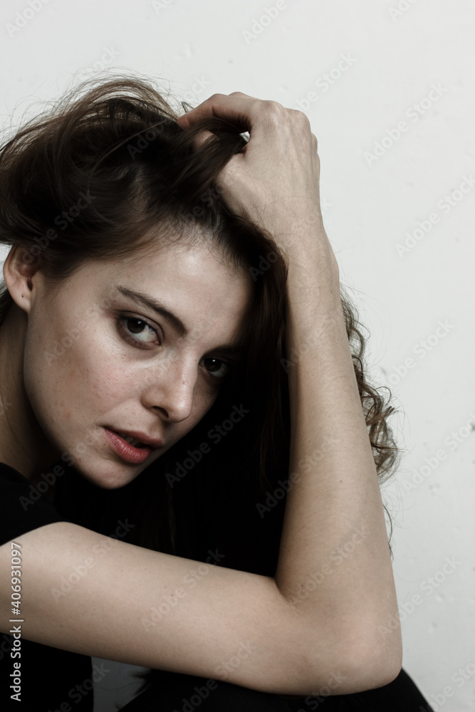 Fototapeta premium Portrait of woman. Model holds her head