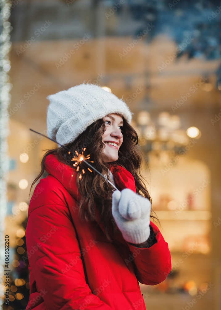 beautiful cheerful girl holding Christmas sparklers