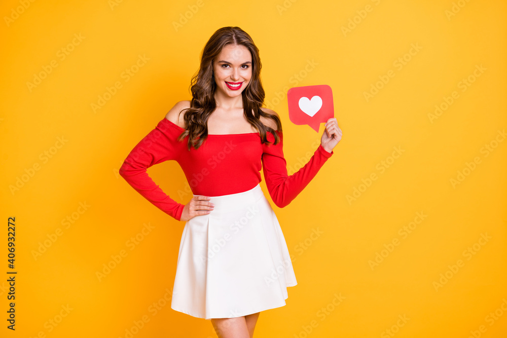 Photo portrait of girl wearing white skirt off-shoulders top keeping heart icon social media isolated on bright yellow color background Photo portrait of girl wearing white skirt off-shoulders top keeping heart icon social media isolated on bright yellow color background