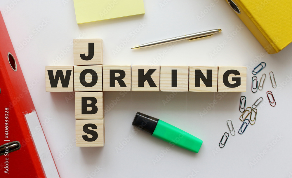 Wooden cubes with words JOBS WORKING on the office desk. Folder and other office supplies. Wooden cubes with words JOBS WORKING on the office desk. Folder and other office supplies.