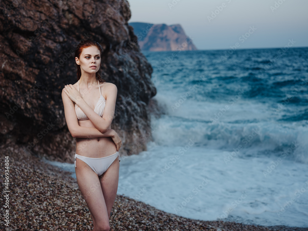 Obraz premium Elegant Woman in White Swimsuit Bare Shoulders Transparent Water Ocean Beach Nature