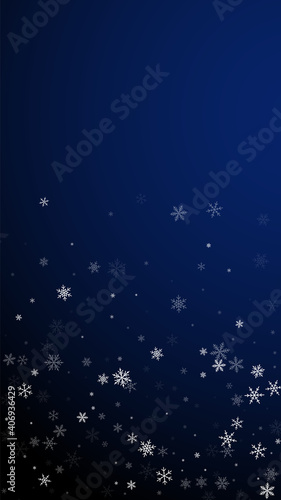 Sparse snowfall Christmas background. Subtle flying snow flakes and stars on dark blue background. Amusing winter silver snowflake overlay template. Ecstatic vertical illustration.