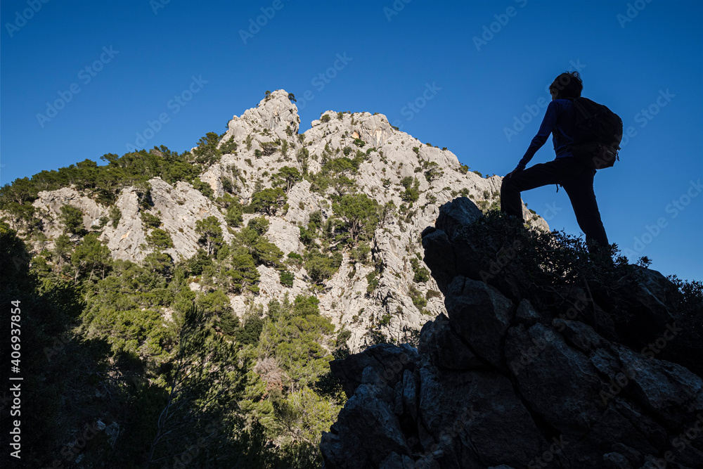 silhouette of a hiker in front of Puig d'en Grau, 867 m , Escorca, Mallorca, Balearic Islands, Spain