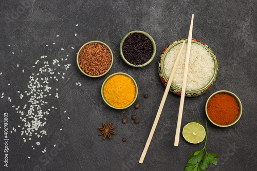 Different types of rice and dry spices in bowls