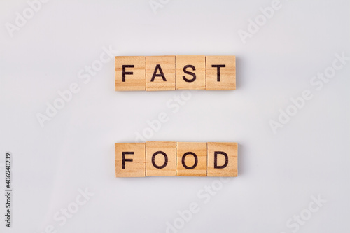Fast food concept. Wooden blocks on white background vertical shot.