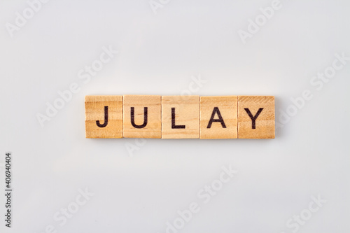 Julay word written on wooden blocks. Isolated on white background.