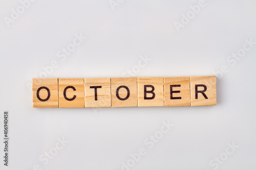 October word written on wooden blocks. Isolated on white background.