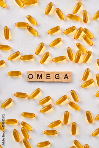 Yellow omega pills. Many healthy vitamins on white background.