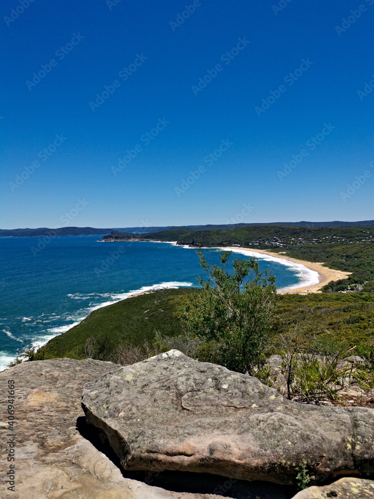 Beautiful view of a deep blue sea and sandy beach from a mountain lookout, Bullimah Lookout, Bouddi National Park, National Park, New South Wales, Australia
