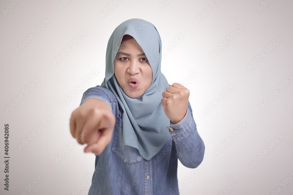 Muslim Woman Pointing at Camera with Angry Expression, Giving Warn Muslim Woman Pointing at Camera with Angry Expression, Giving Warn