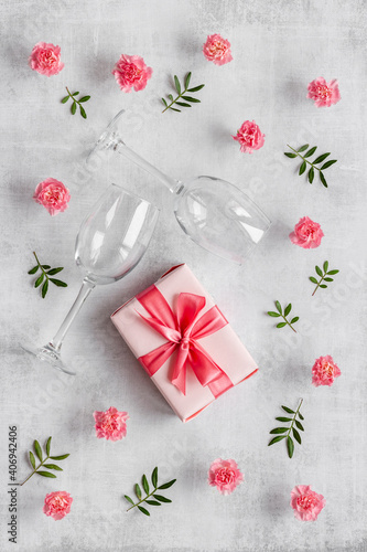 Valentines Day pattern of pink gift box and flowers. Overhead view