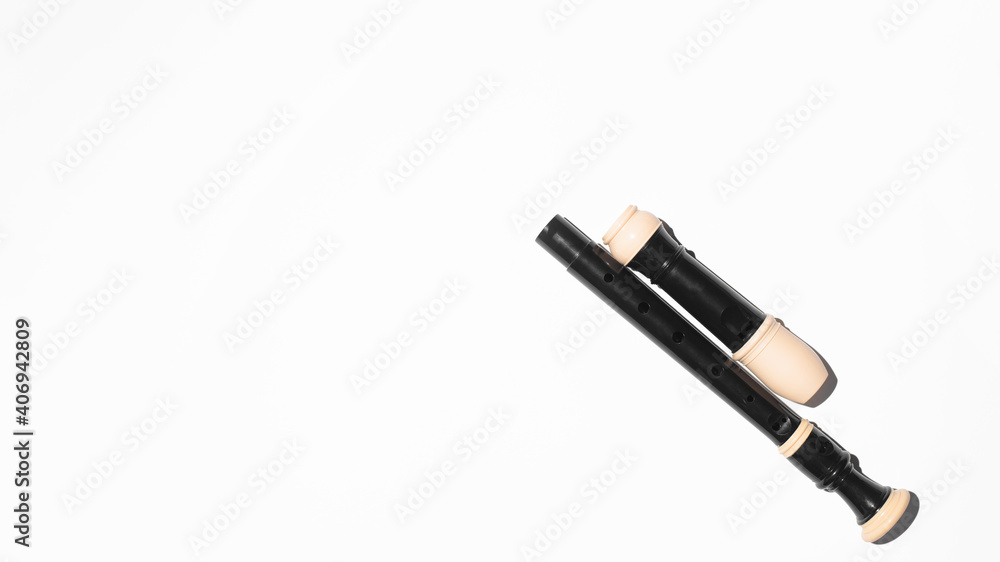 Disassembled musical flute on a white background, copy space. Top view Disassembled musical flute on a white background, copy space. Top view