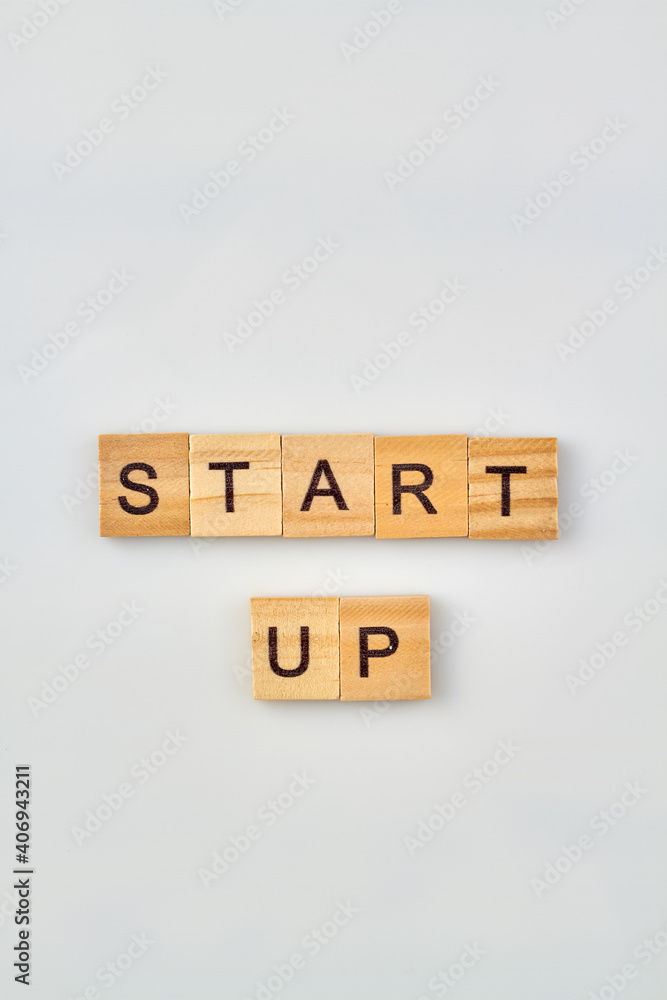 Concept of new business project. Start up words written with wooden letter blocks isolated on white background. Concept of new business project. Start up words written with wooden letter blocks isolated on white background.