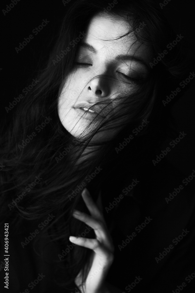 Emotional Sensual black and white portrait of a beautiful girl on a dark background Emotional Sensual black and white portrait of a beautiful girl on a dark background