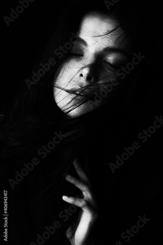 Emotional Sensual black and white portrait of a beautiful girl on a dark background