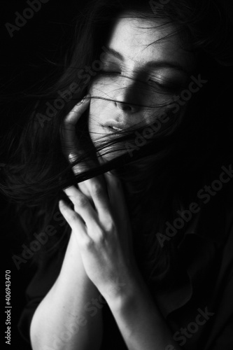Emotional Sensual black and white portrait of a beautiful girl on a dark background © Zaliya