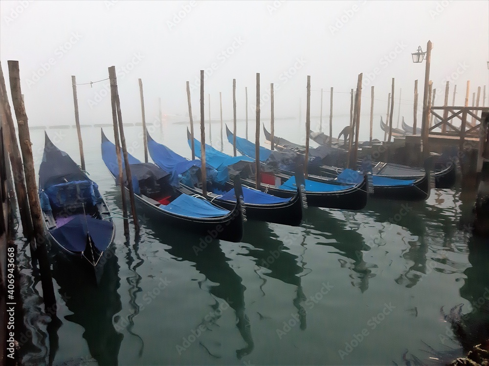 Venice, Italy, January 27, 2020 evocative image of gondolas moored along a pier
