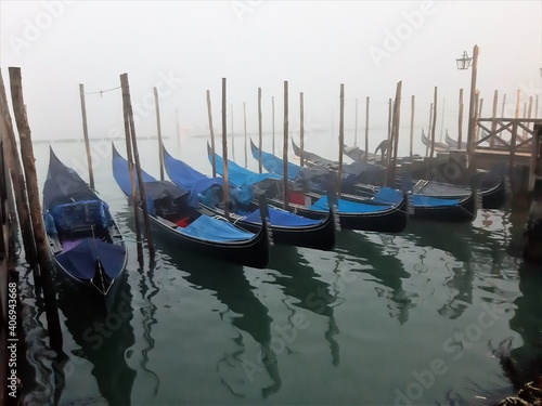 Venice, Italy, January 27, 2020 evocative image of gondolas moored along a pier  © massimo