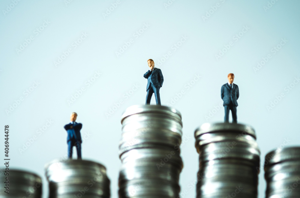 Miniature people businessman on top of stacks coins in money communication on white background Miniature people businessman on top of stacks coins in money communication on white background
