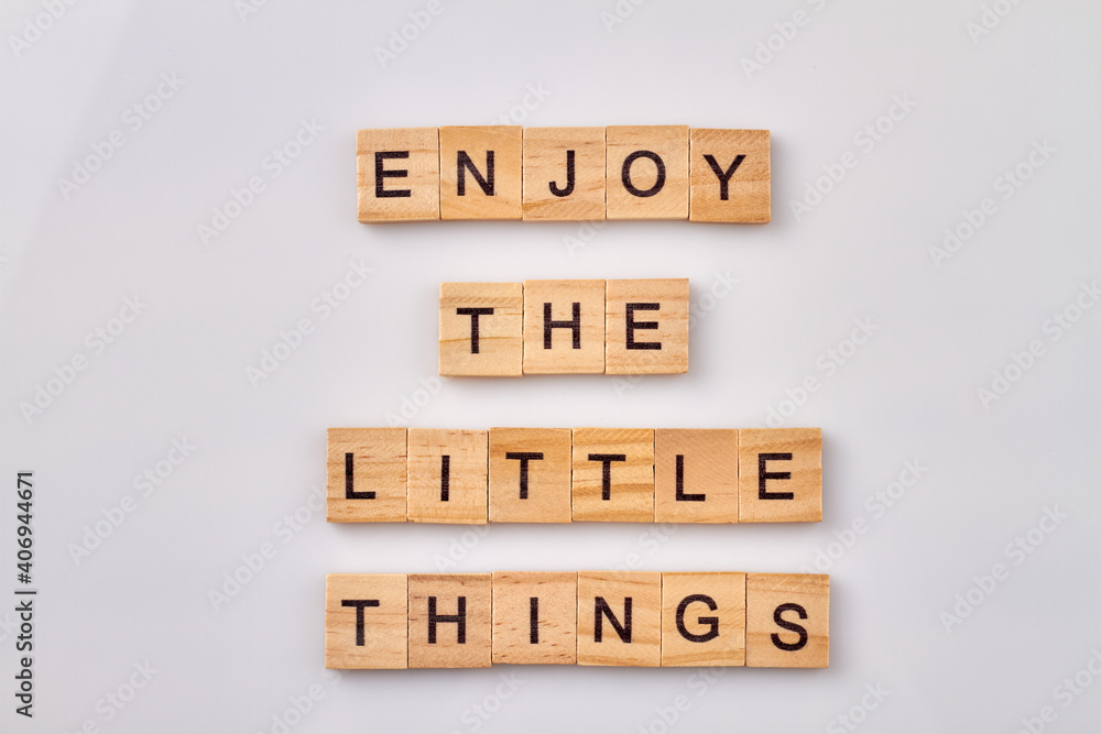 For happiness you need to value small joys. Enjoy the little things. Wooden cubes with letters isolated on white background. For happiness you need to value small joys. Enjoy the little things. Wooden cubes with letters isolated on white background.