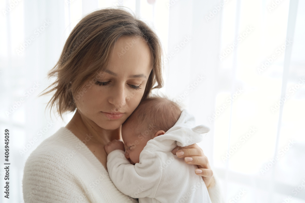 Beautiful woman breastfeeding her baby in a cozy house on the bed. High quality photo Beautiful woman breastfeeding her baby in a cozy house on the bed. High quality photo