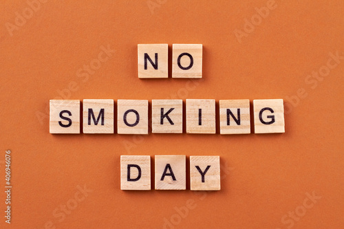 Smoking is unhealthy habit. Fighting a bad habit. Wooden blocks with letters isolated on orange background.