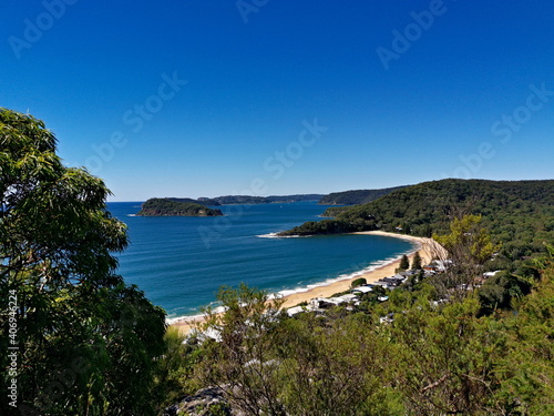 Beautiful view of a deep blue sea with white sandy beach, small island and deep blue sky in the background, Mount Ettalong Lookout, Pearl Beach, Brisbane Water National Park, New South Wales, Australi