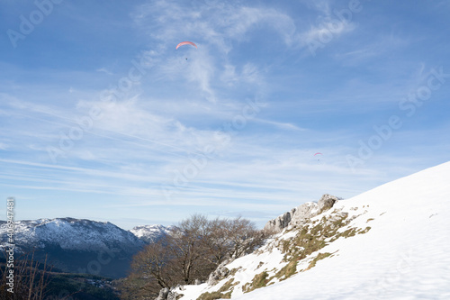 paragliders flying over the mountains 