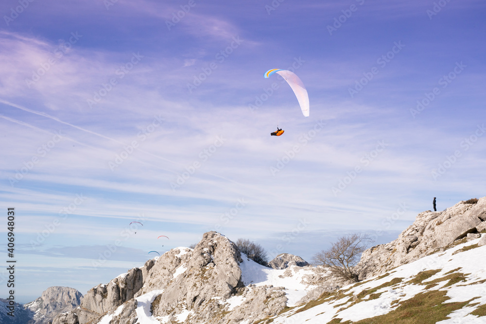 paragliders flying over the mountains paragliders flying over the mountains