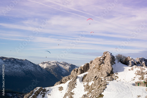 paragliders flying over the mountains  photo