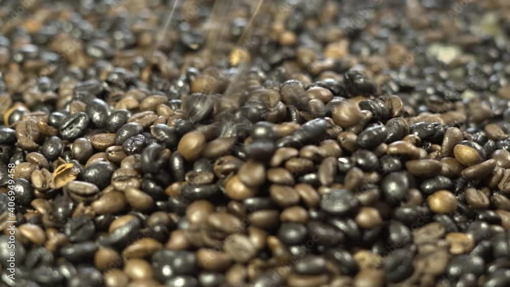 Pour the black and brown coffee beans into a light brown cloth bag.street coffee seeds from sack Pour the black and brown coffee beans into a light brown cloth bag.street coffee seeds from sack