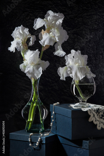 Still life with white irises. Bouquet of irises in a glass vase