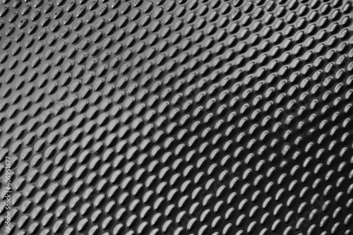 Dark metallic ellipse pattern texture background.