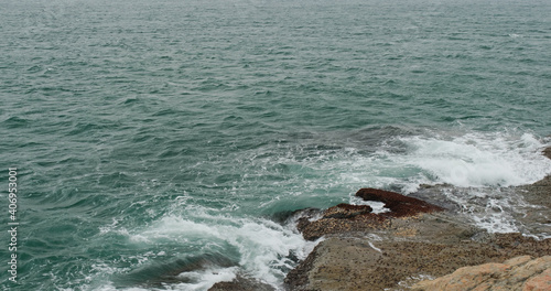 Ocean waves splash against rocks