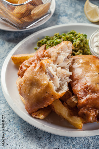 Fish in beer batter and chips with green pea and tartar sauce