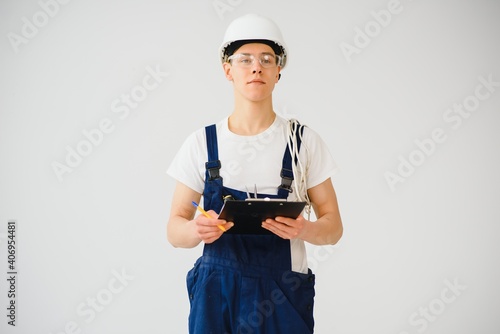 Full length of mid adult service man taking notes over white background