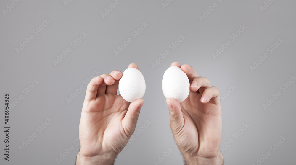 Male hands holding white chicken eggs. Male hands holding white chicken eggs.