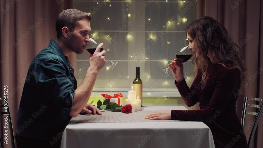Two people in love drink red wine in glasses during dinner. Romantic dinner. Valentine's Day. Two people in love drink red wine in glasses during dinner. Romantic dinner. Valentine's Day.