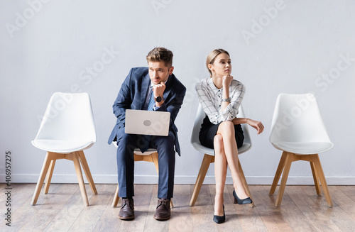 Business people with laptop waiting job interview in hall