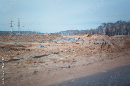 Excavator at quarry drips road