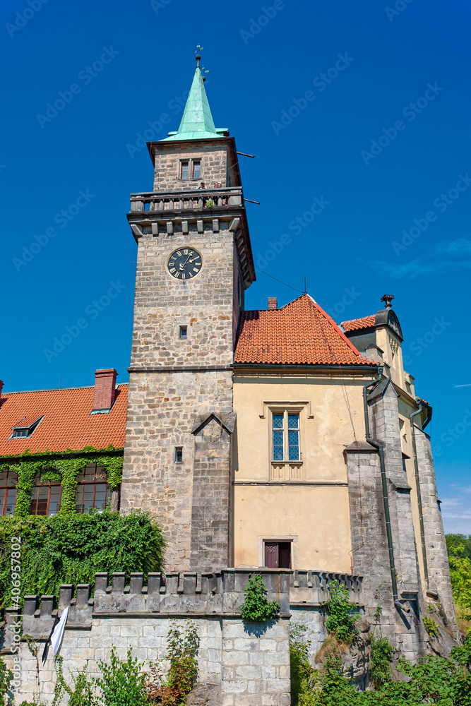 The tower of Hruba Skala Castle surrounded by Czech Paradise Park , Czech Republic