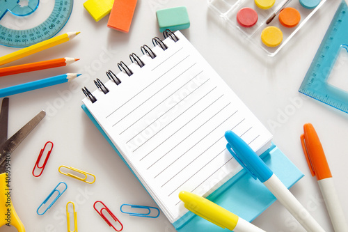Children education. Accessories, school supplies, colored pencils and a drawing pad of Trendy colors on white background . The concept of school children's creativity and "Back to school" concept.