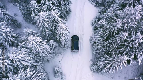 Offroad car trip through the Ukrainian Carpathians in winter. Christmas tree and snowy road. External expedition.Ice. Aerial view photo